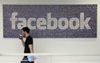 FILE - In this March 15, 2013, file photo, a man walks past a sign at Facebook headquarters in Menlo Park, California, USA. Facebook gave some compani