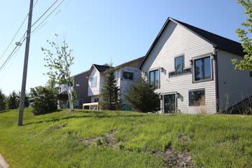 Detached townhomes look much like traditional single-family homes but are built on smaller lots. Here, a townhome is shown under construction.