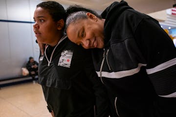 Latasha Bacon leans on her son Davonte, 13, as they shop at Northtown Mall in Blaine Friday. When Davonte and his sister Layla Jackson were taken from