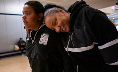 Latasha Bacon leans on her son Davonte, 13, as they shop at Northtown Mall in Blaine Friday. When Davonte and his sister Layla Jackson were taken from