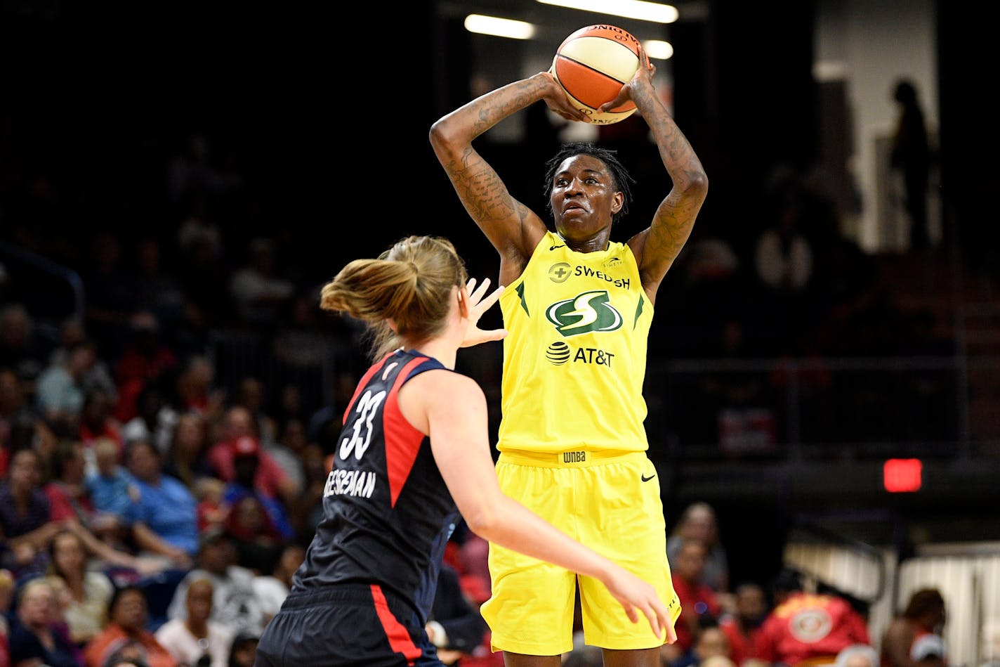 Seattle Storm forward Natasha Howard, right, shoots over Washington Mystics center Emma Meesseman (33) during the first half of a WNBA basketball game Wednesday, Aug. 14, 2019, in Washington. (AP Photo/Nick Wass)