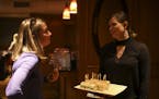 Orionna Brisbois, left, who was overseeing a function at Muse Event Center, chatted with Emily Torgrimson of Eat for Equity as she delivered a tray of
