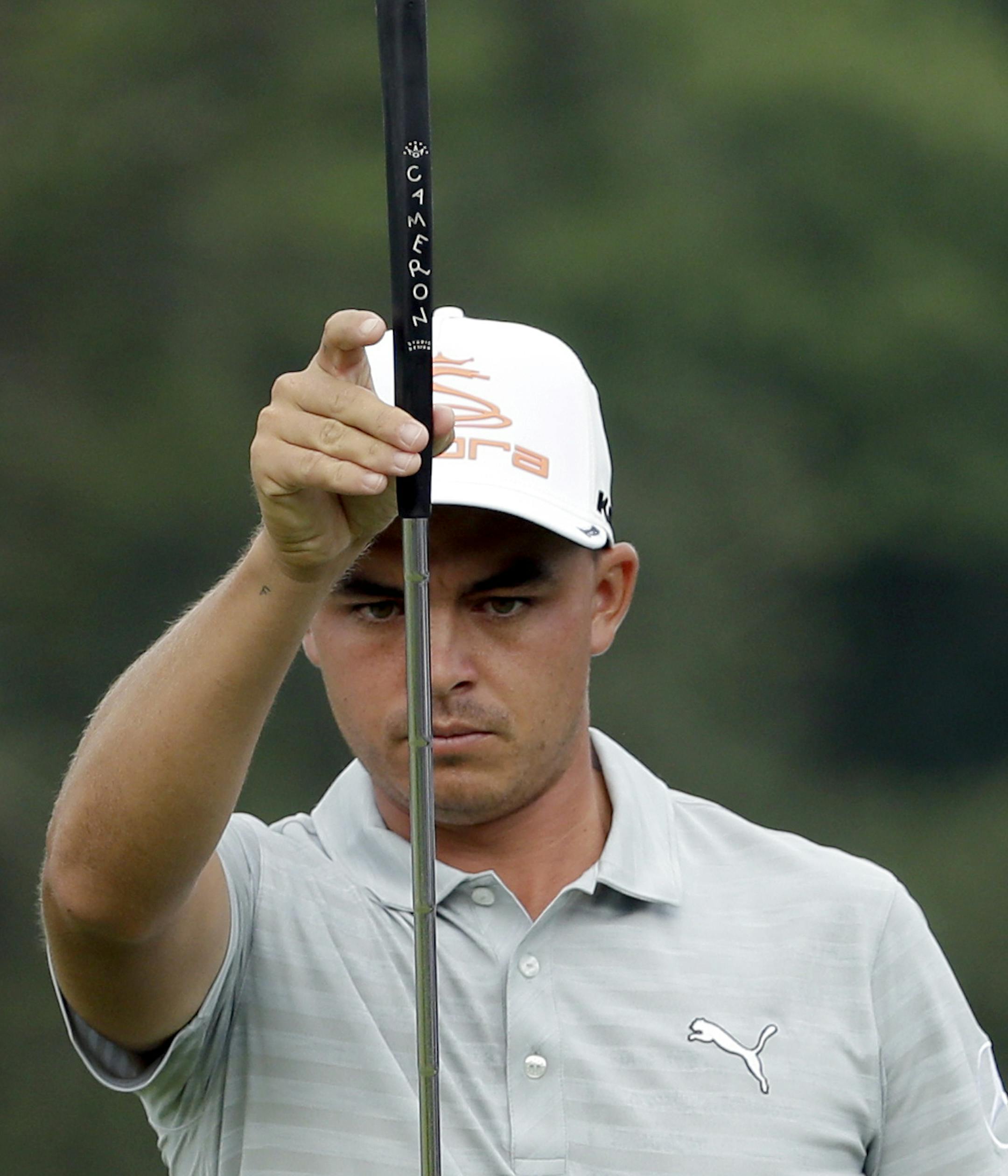 Rickie Fowler lines up a putt on the 10th hole during the first round of the Wyndham Championship golf tournament in Greensboro, N.C., Thursday, Aug. 18, 2016. (AP Photo/Chuck Burton) ORG XMIT: NCCB106