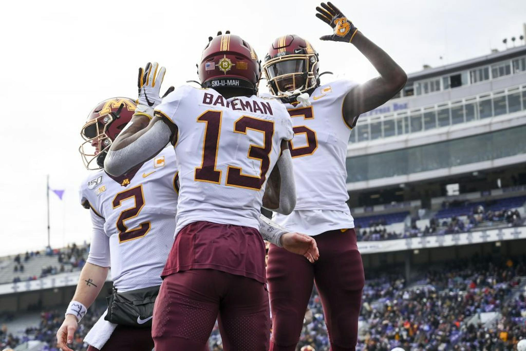 Minnesota Gophers quarterback Tanner Morgan (2), wide receiver Rashod Bateman (13) and wide receiver Tyler Johnson (6) celebrated Bateman's third touchdown reception of the game in the third quarter Saturday.