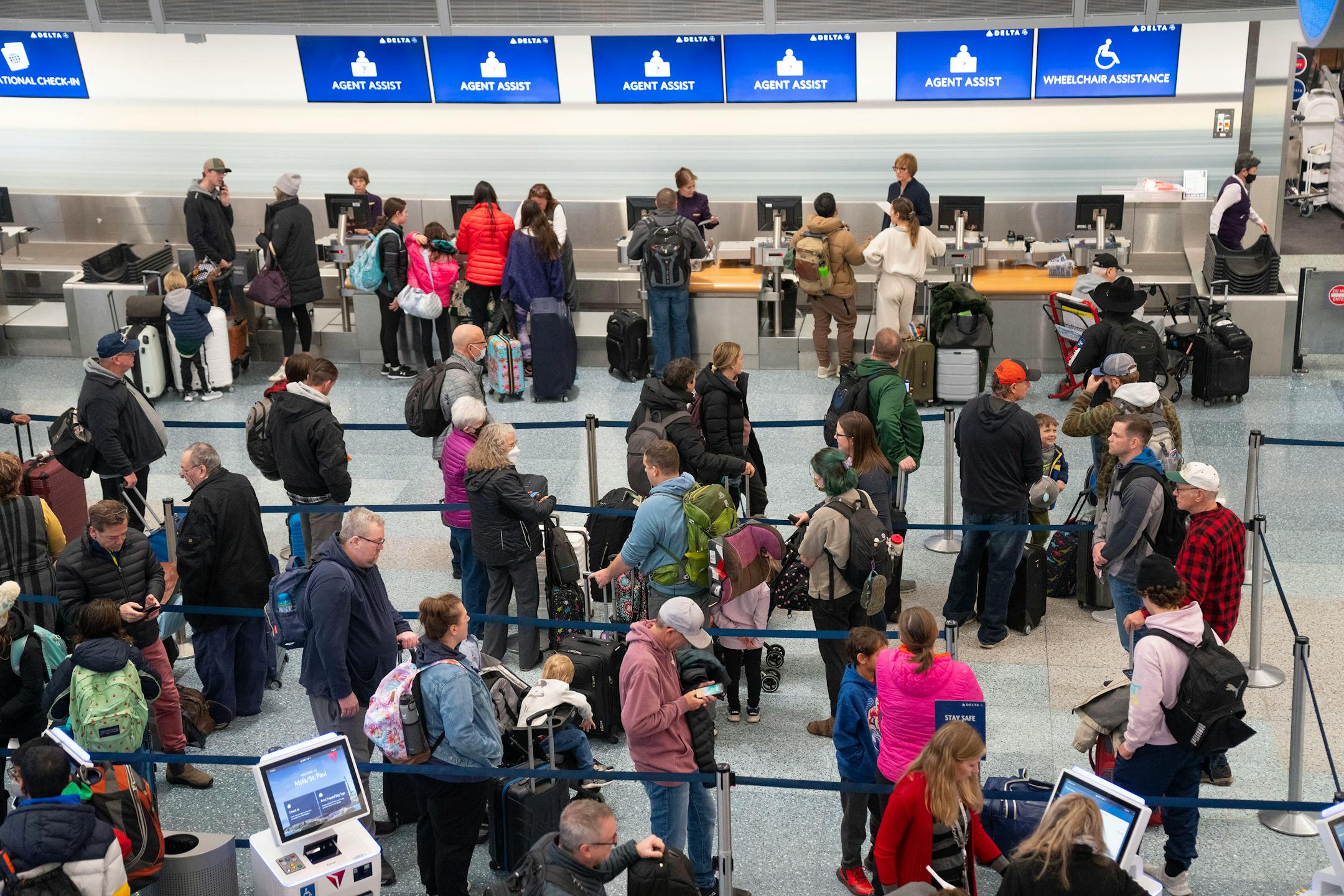Travelers wait in line at the Delta check-in area in Terminal 1 of the Minneapolis-Saint Paul International Airport.