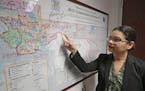 In this Monday, June 3, 2019, photo, Orange County Commissioner Emily Bonilla looks at a map of Orange County and the city of Orlando in Orlando, Fla.