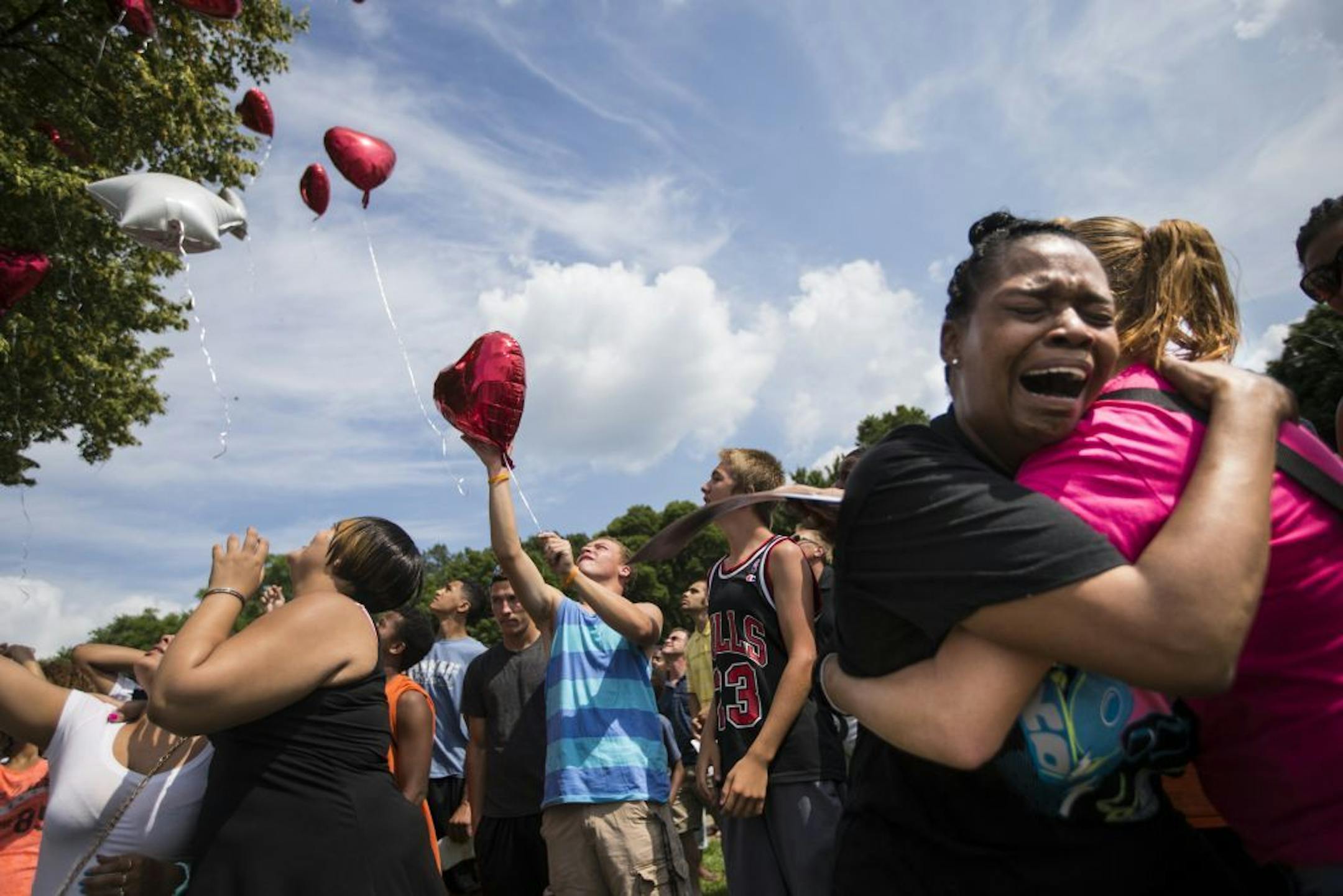 Kimberly Adama, Sha-kim's mother, wept as a group of family and friends released balloons in the air in his memory during a memorial on Thursday, August 7, 2014 at the East beach at Lake Nokomis where 15-year-old Sha-Kym Adams drowned yesterday while at the beach with his friends.