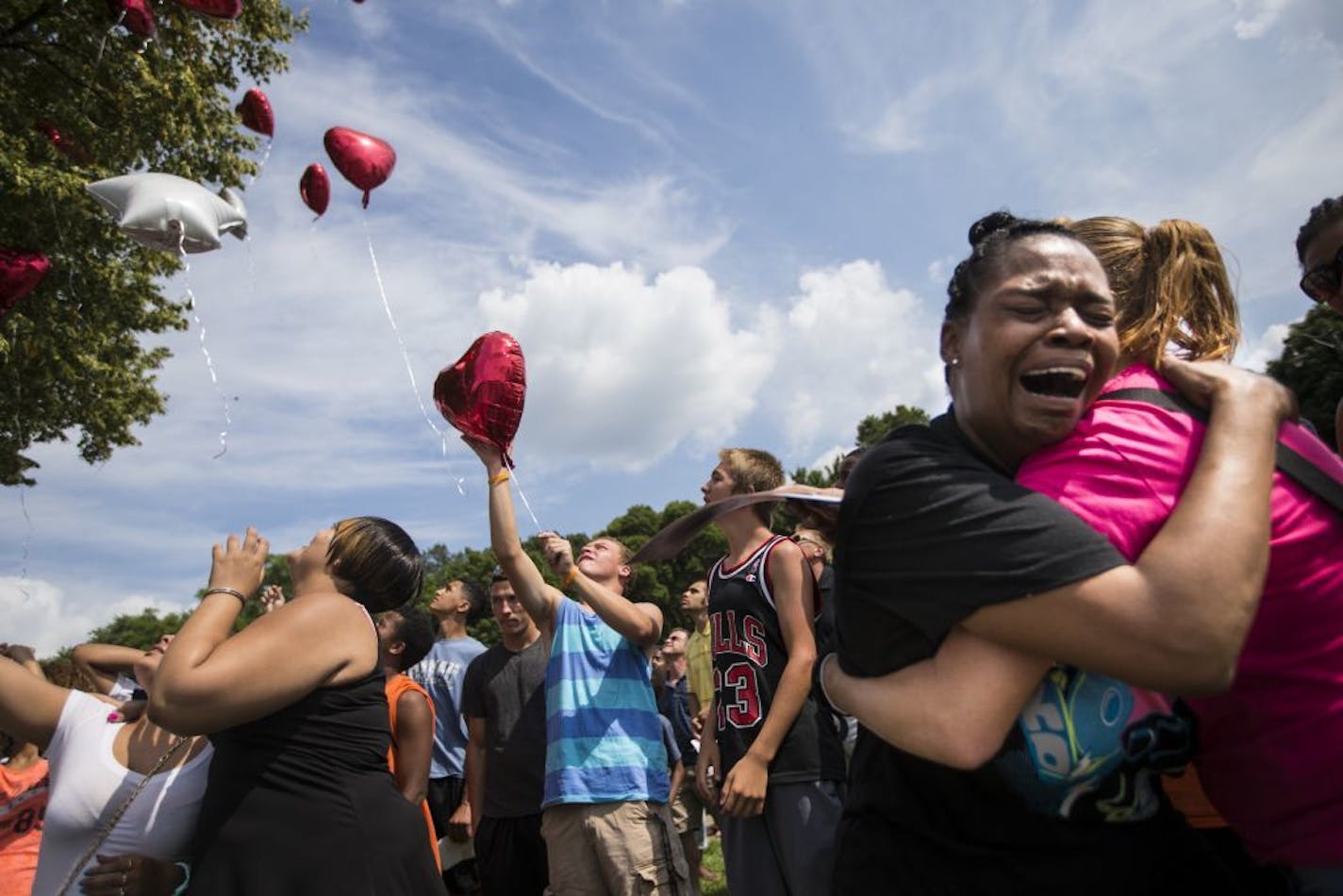 Kimberly Adama, Sha-kim's mother, wept as a group of family and friends released balloons in the air in his memory during a memorial on Thursday, August 7, 2014 at the East beach at Lake Nokomis where 15-year-old Sha-Kym Adams drowned yesterday while at the beach with his friends.