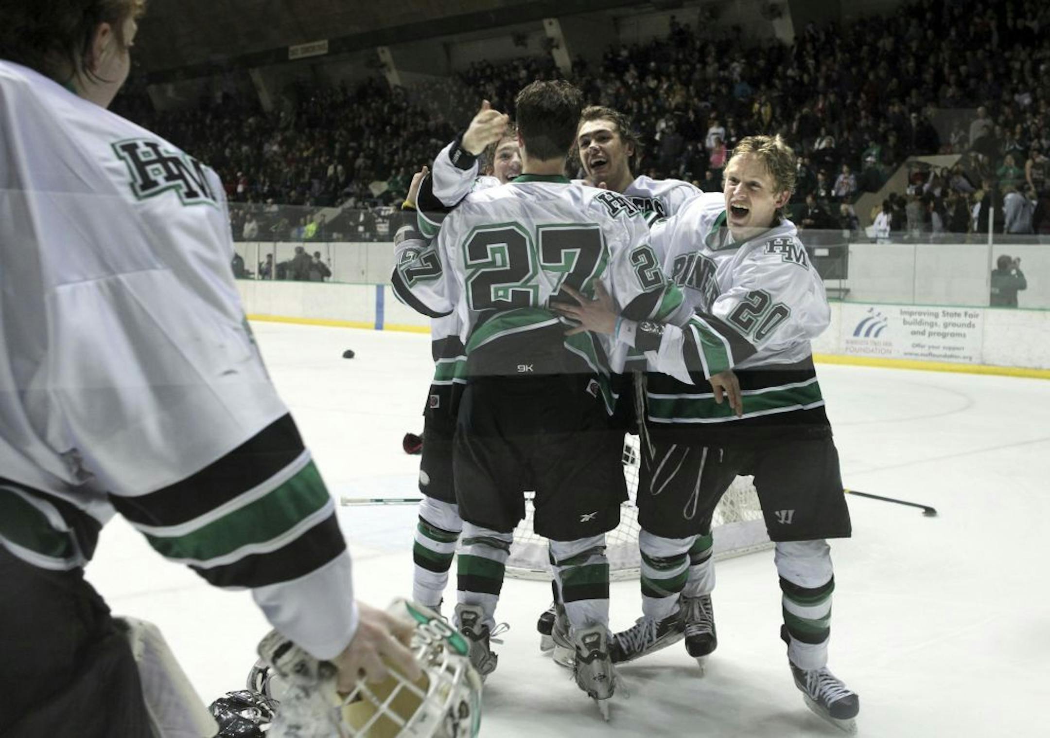 The Hill-Murray Pioneers celebrate their 3-2 hockey win over the Roseville Raiders at Warner Coliseum in Falcon Heights March 2, 2012.