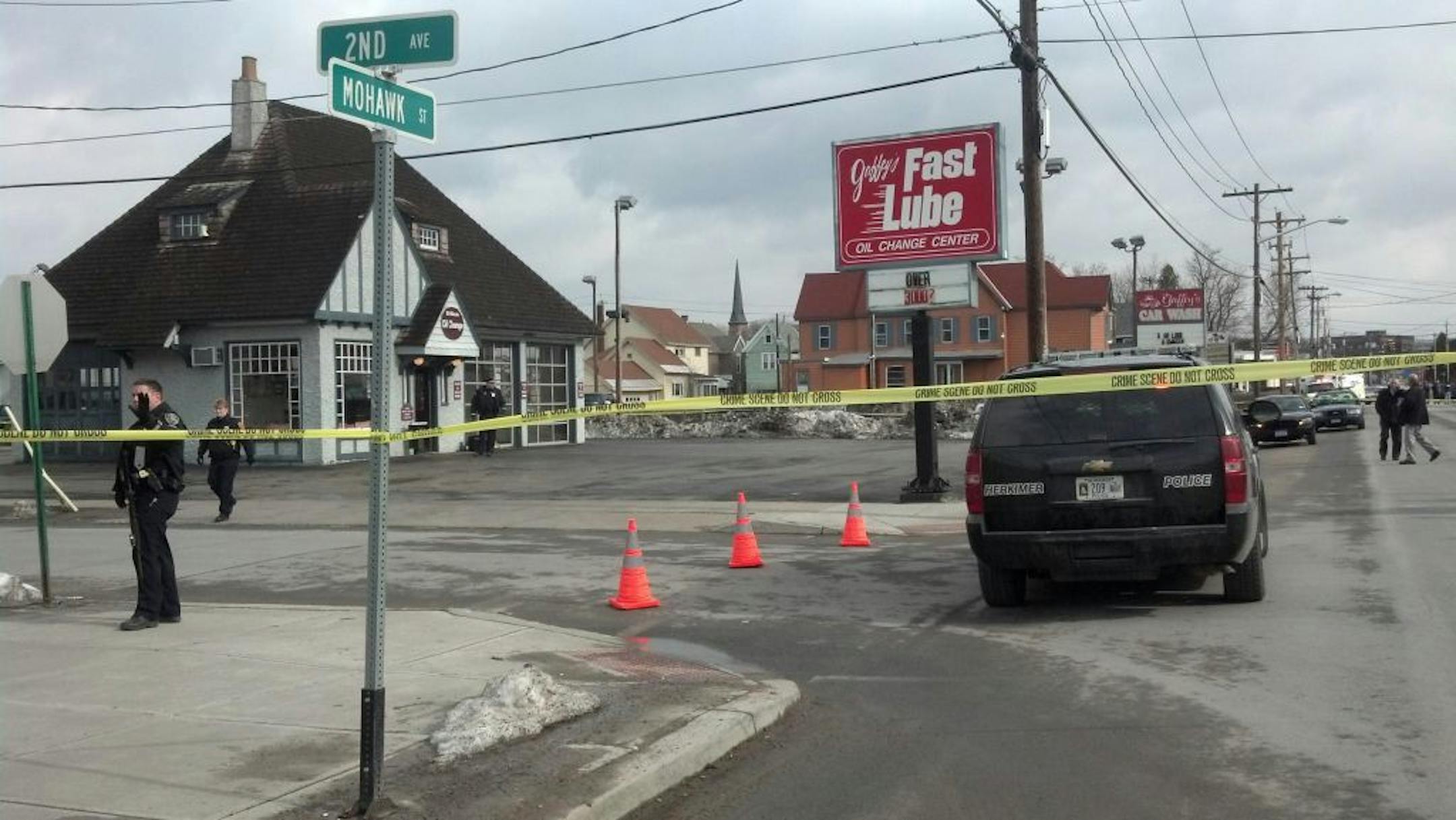 Emergency crews work at the scene of a shooting at Gaffey's car wash in the village of Herkimer, N.Y. after shootings at two different businesses left four people dead and at least two wounded, according to police, Wednesday, March 13, 2013. Police said two unidentified people were shot and killed at the car wash and two others were killed in a barber shop in the village of Mohawk, east of Syracuse.