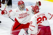 Boston University's Sam Stevens, left, and Lane Hutson celebrate Hutson's go-ahead second-period goal against the Gophers on Saturday in Sioux Falls, 
