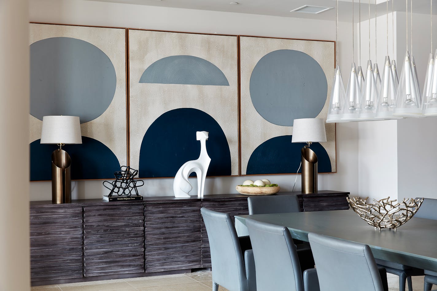 A triptych featuring indigo as its primary color takes center stage in this dining space. (Scott Gabriel Morris/Provided photo/TNS)