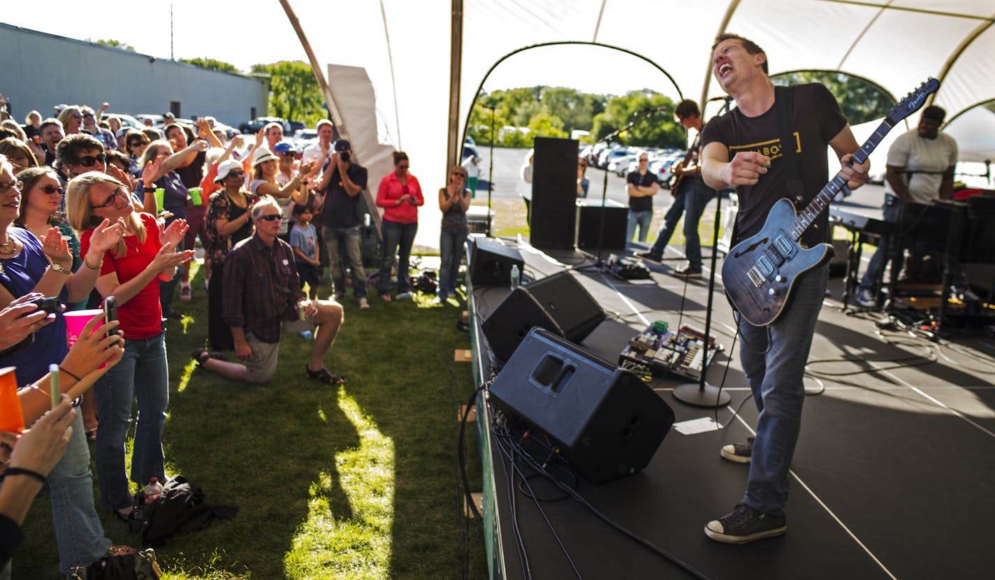 At Bi Worldwide headquarters, blues artist Johnny Lang played an outdoor concert as free beer flowed and 10 food trucks catered in another parking lot .] Richard Tsong-Taatarii/rtsong-taatarii@startribune.com