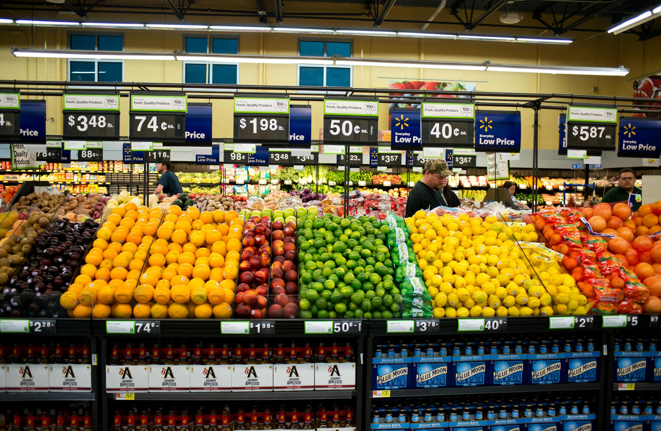 In this Tuesday, June 4, 2014 photo, [eople shop the produce department at Wal-Mart Neighborhood Market in Bentonville, Ark. The Commerce Department reports on business inventories for June on Wednesday, Aug. 13, 2014. (AP Photo/Sarah Bentham)