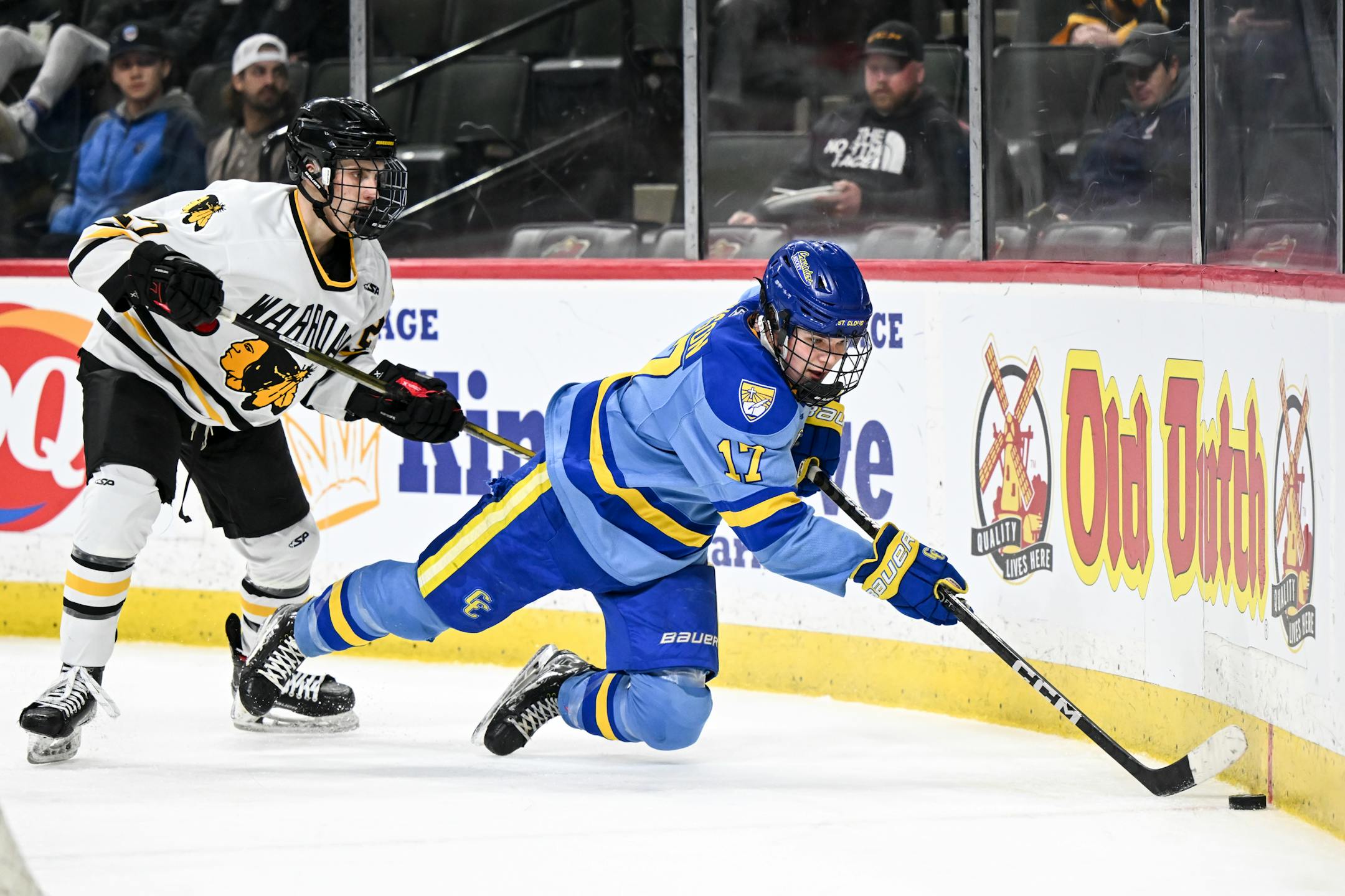 St. Cloud Cathedral forward Landon Swenson (17) leaps to pass the puck in front of the net against Warroad during the second period.