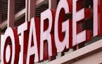 A Target sign is shown on the front of a Target Store.