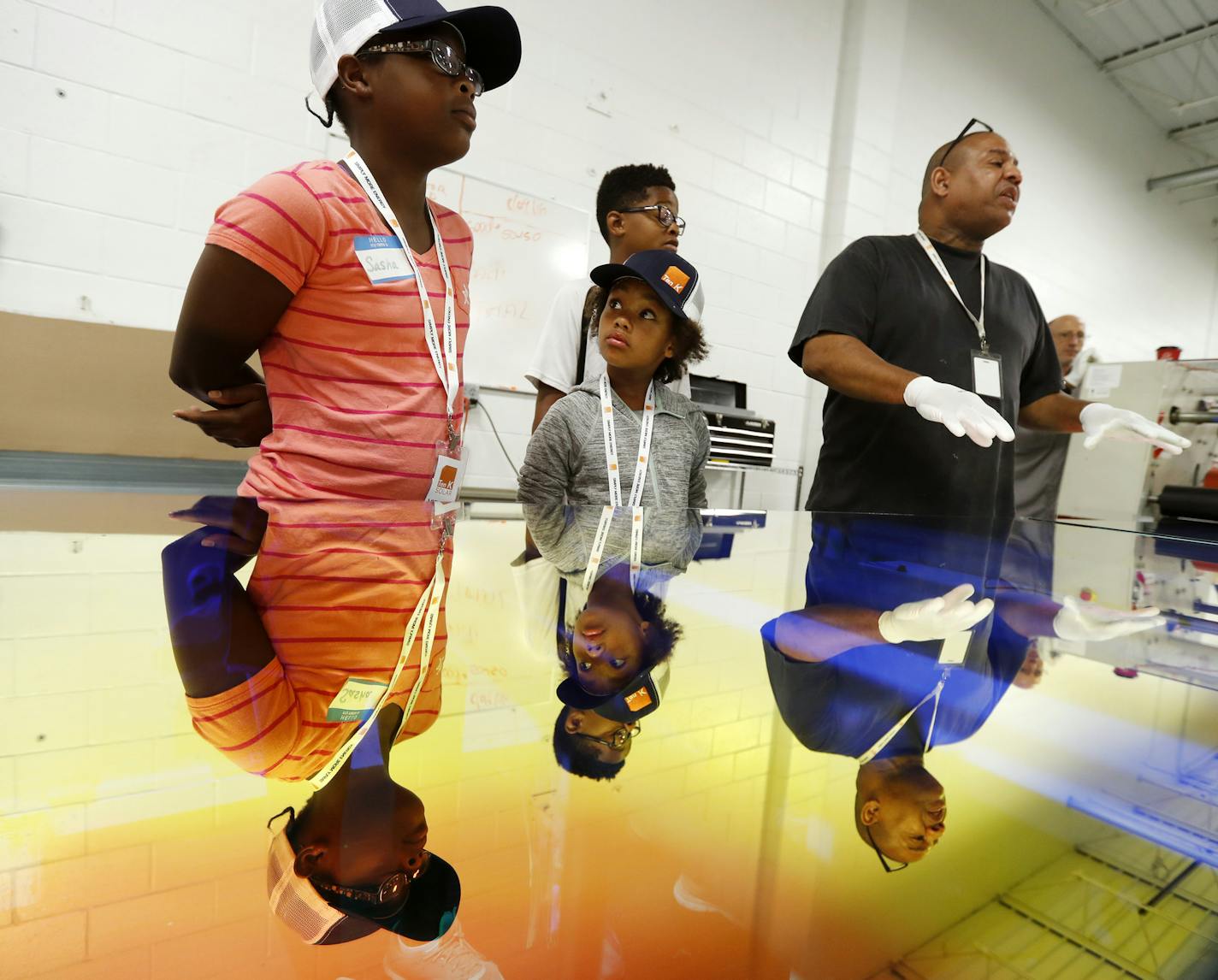 Craig Lee of Ten K Solar, center, explained his job to kids from the Just B Solar camp at Shiloh Temple in north Minneapolis.