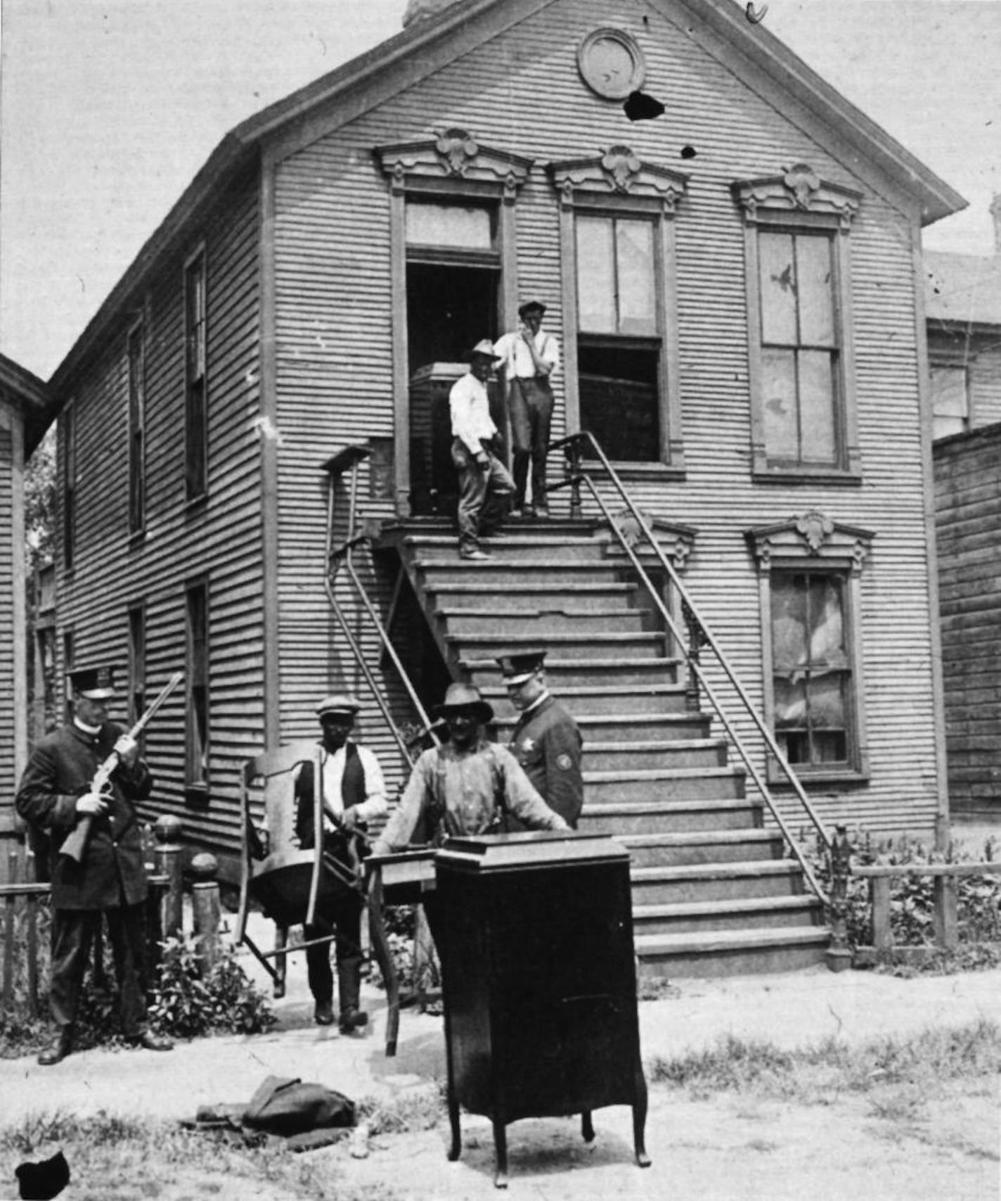 An African American family evacuates their house after it was vandalized in the 1919 Chicago race riot. Photo New York Public Library/Schomburg Center for Research in Black Culture