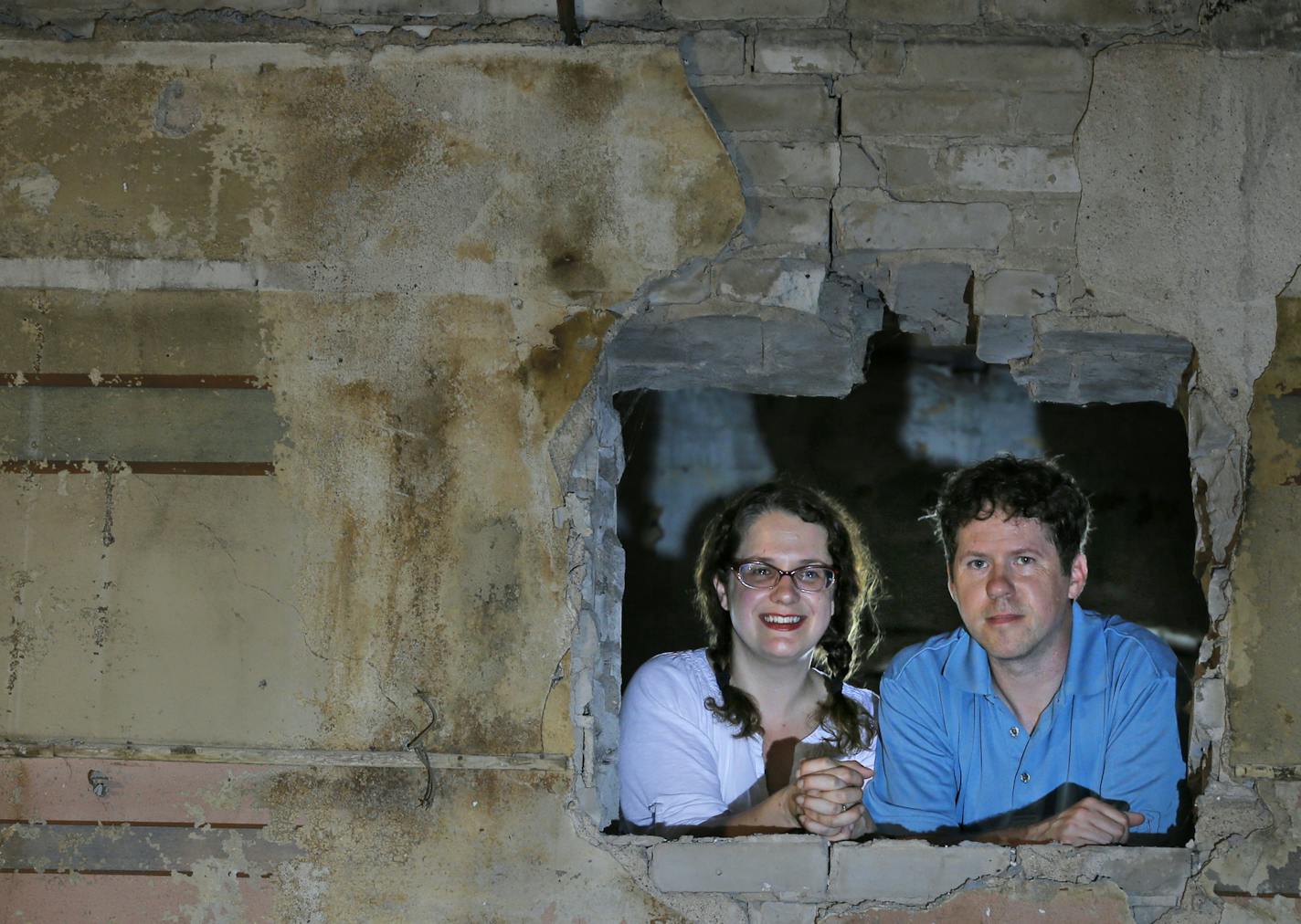 Tina and Ryan North peeked out of what was the projector booth at the old theater.