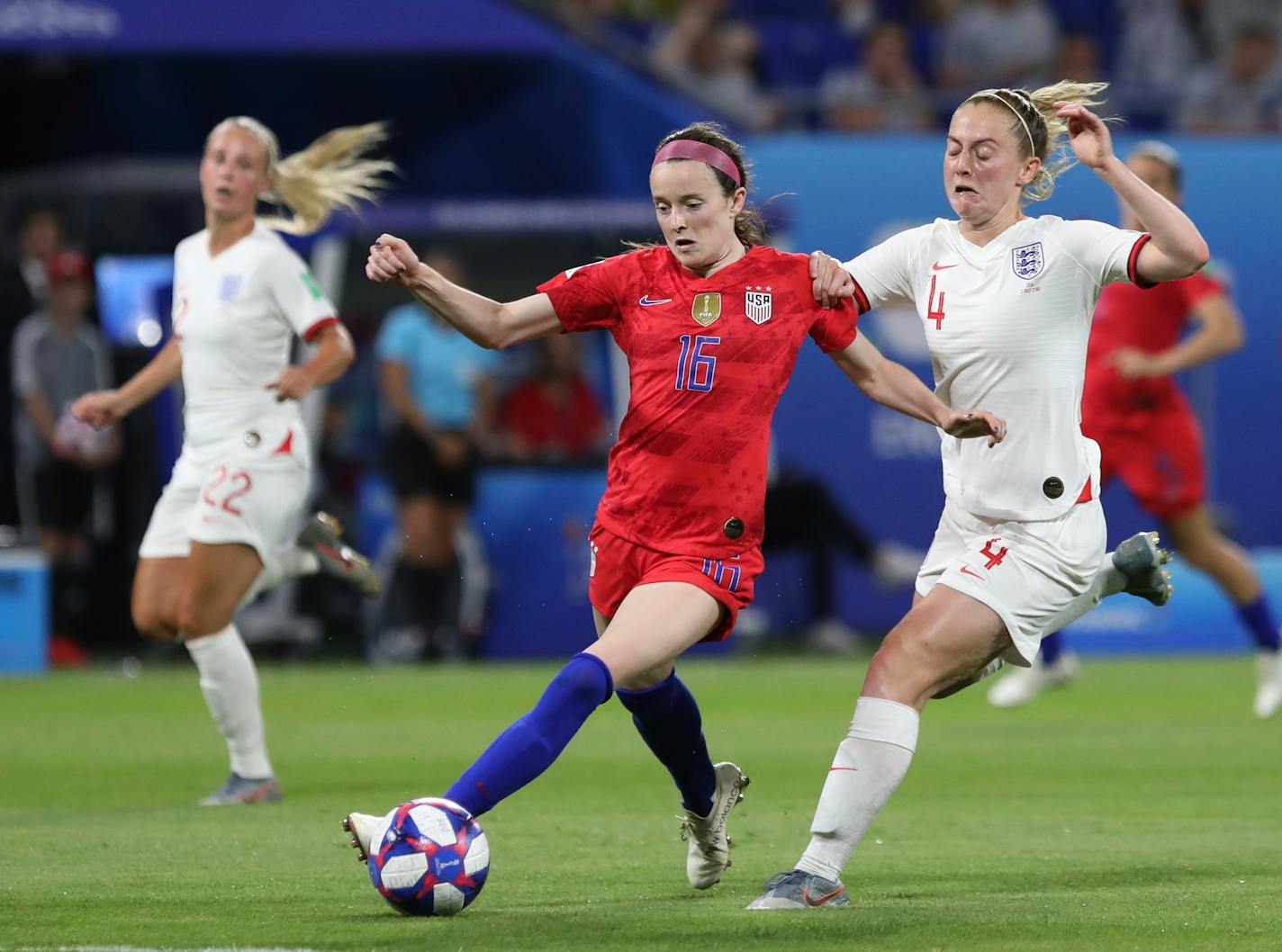 United States' Rose Lavelle, left, and England's Keira Walsh challenge for the ball during the Women's World Cup semifinal soccer match between England and the United States, at the Stade de Lyon outside Lyon, France, Tuesday, July 2, 2019. (AP Photo/Laurent Cipriani)