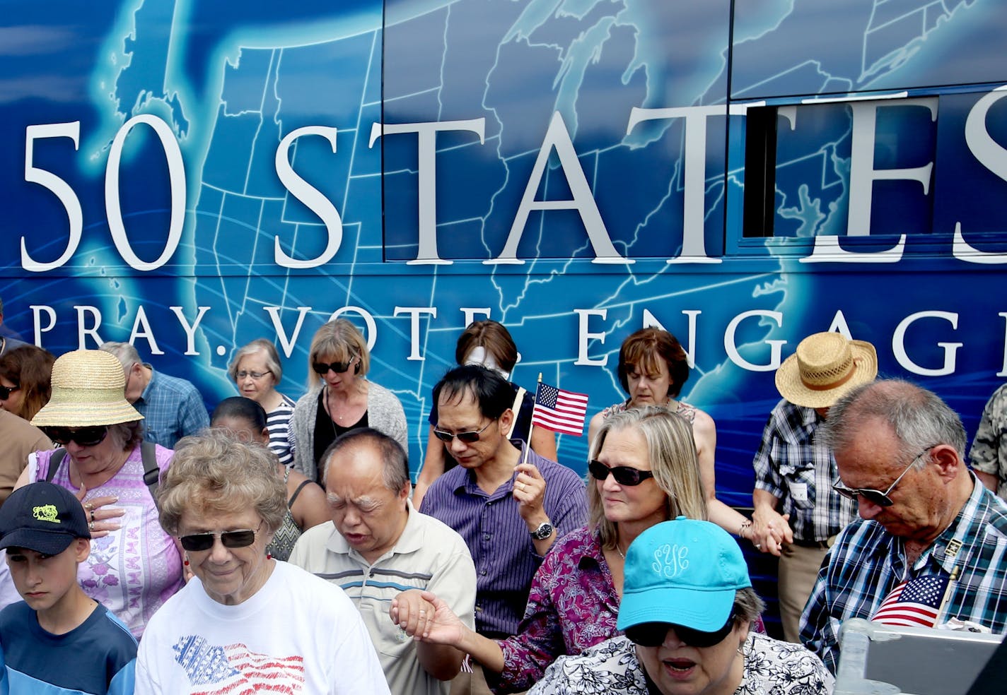 The Rev. Franklin Graham hosted a day of prayer, encouraging the throng of Christians gathered to get out and vote and become involved in politics on the local level Thursday, June 16, 2016, in the lower mall outside the State Capitol in St. Paul, MN. Here, those gathered prayed.