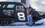Lake of the Woods fishing legend Kit Beckel stood next to a &#x201c;Bomber,&#x201d; the type of ice-crossing rig that enabled winter anglers a faster,
