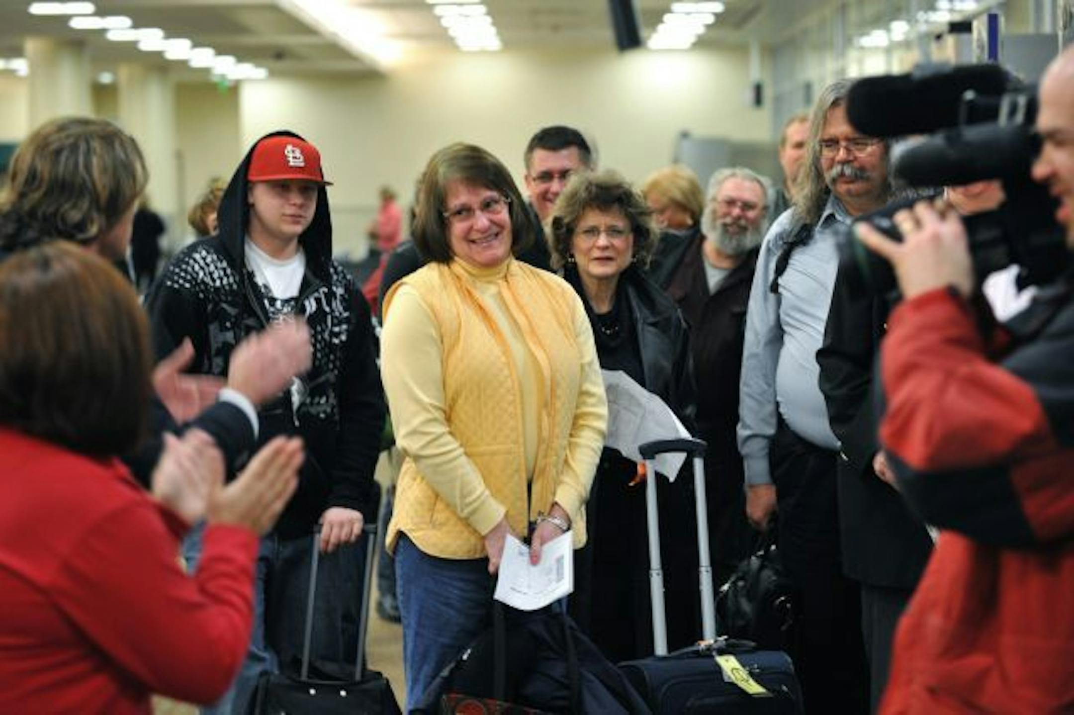Mary Kone of Brooklyn Park joined in as Southwest Airlines crew led waiting passengers in a cheer.