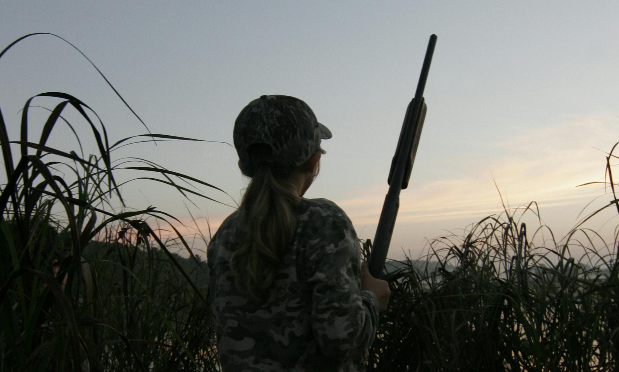 Grace Rodemann, 11, of Carver, scans the sky for ducks during Youth Waterfowl Day in Minnesota.