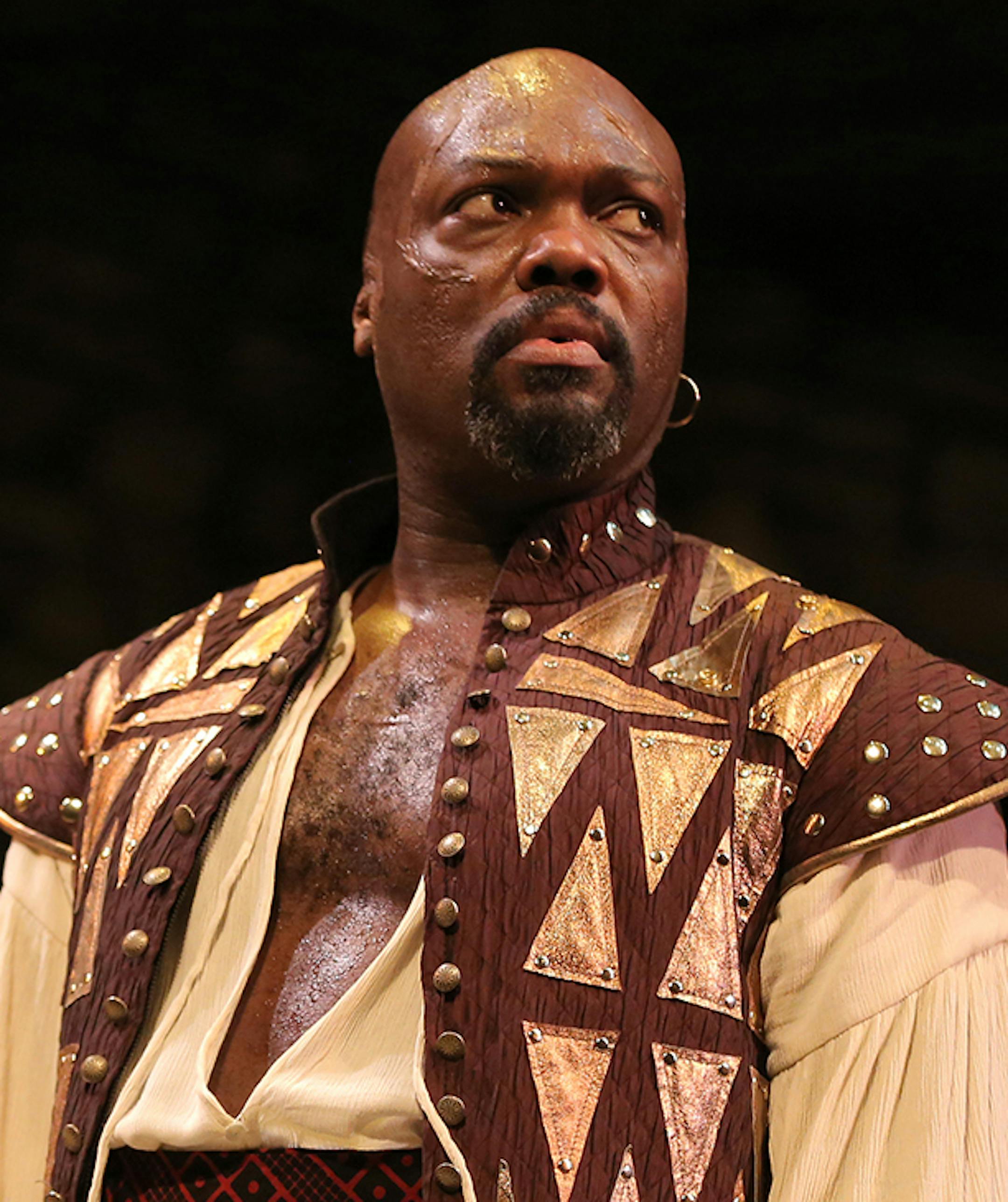 Peter Macon (Othello) in the Guthrie's production of Othello, by William Shakespeare. Directed by Marion McClinton, set design by Marjorie Bradley Kellogg, costume design by ESOSA and lighting design by Michael Wangen. March 8 - April 20, 2014 on the Wurtele Thrust Stage at the Guthrie Theater, Minneapolis. Photo by Joan Marcus.