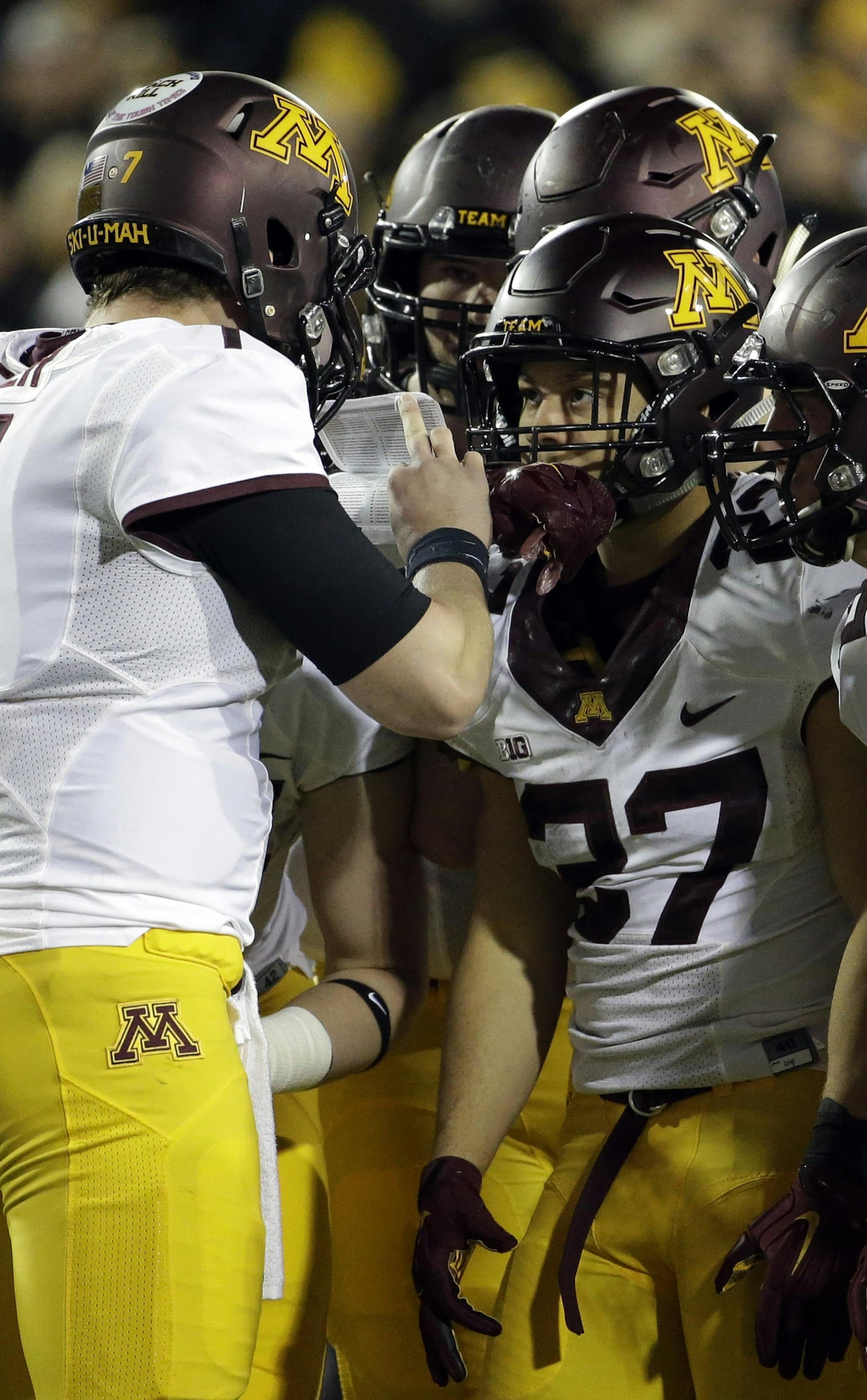 Minnesota quarterback Mitch Leidner (7) talks to teammates during the second half of an NCAA college football game against Iowa, Saturday, Nov.14, 2015, in Iowa City, Iowa. Iowa won 40-35. (AP Photo/Nam Y. Huh) ORG XMIT: MIN2015112418222340