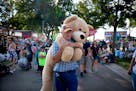 Neil Pence of Northfield carried his prize from a "machine gun BB gun" game at the Midway on day one of the Minnesota State Fair in Falcon Heights, Mi