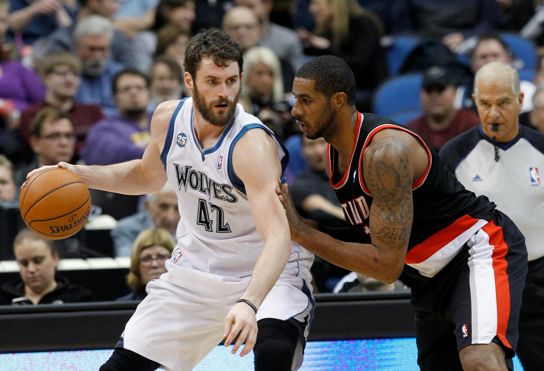 Minnesota Timberwolves forward Kevin Love (42) drives against Portland Trail Blazers forward LaMarcus Aldridge during the first quarter of an NBA basketball game in Minneapolis, Wednesday, Dec. 18, 2013. (AP Photo/Ann Heisenfelt)