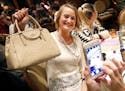 Prize purse: Shannon Witzel of Somerset, Wis., posed for a photo with her designer purse during a charity bingo event at TPC Twin Cities in Blaine.