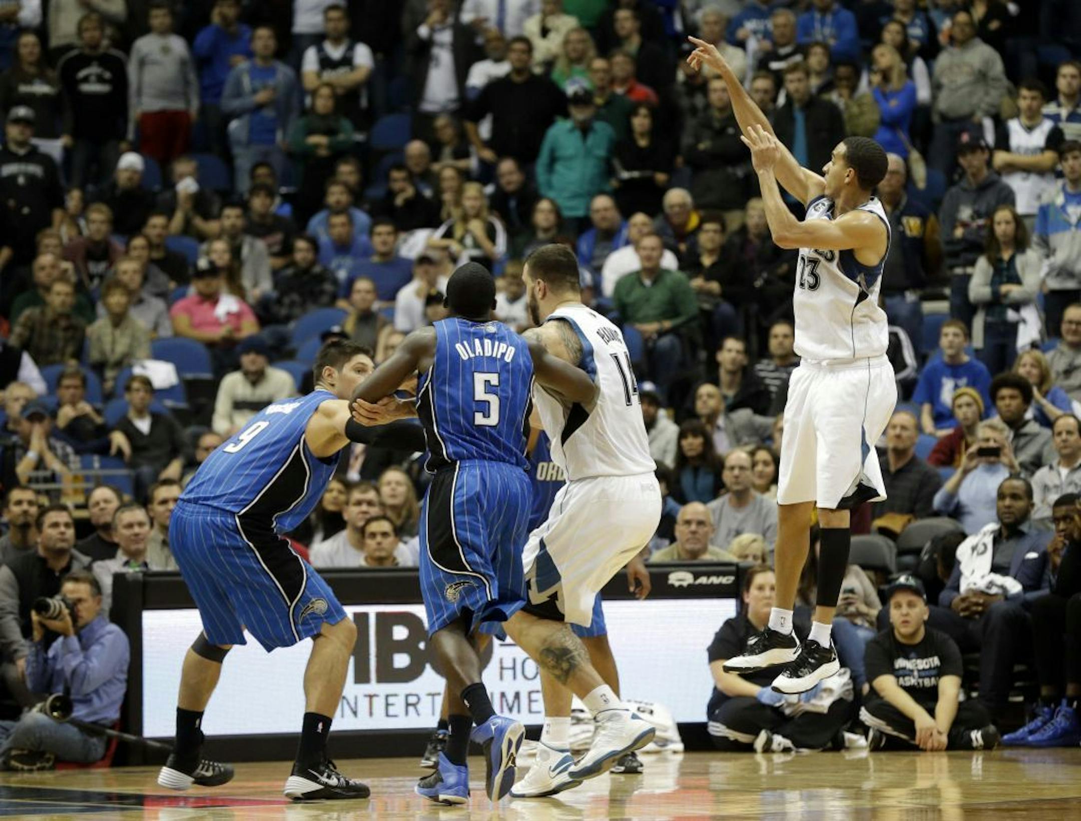 Minnesota Timberwolves' Kevin Martin, right, follows through on a basket in overtime of an NBA basketball game, Wednesday, Oct. 30, 2013 in Minneapolis. Martin scored 23 points as the Timberwolves defeated the Orlando Magic 120-115.