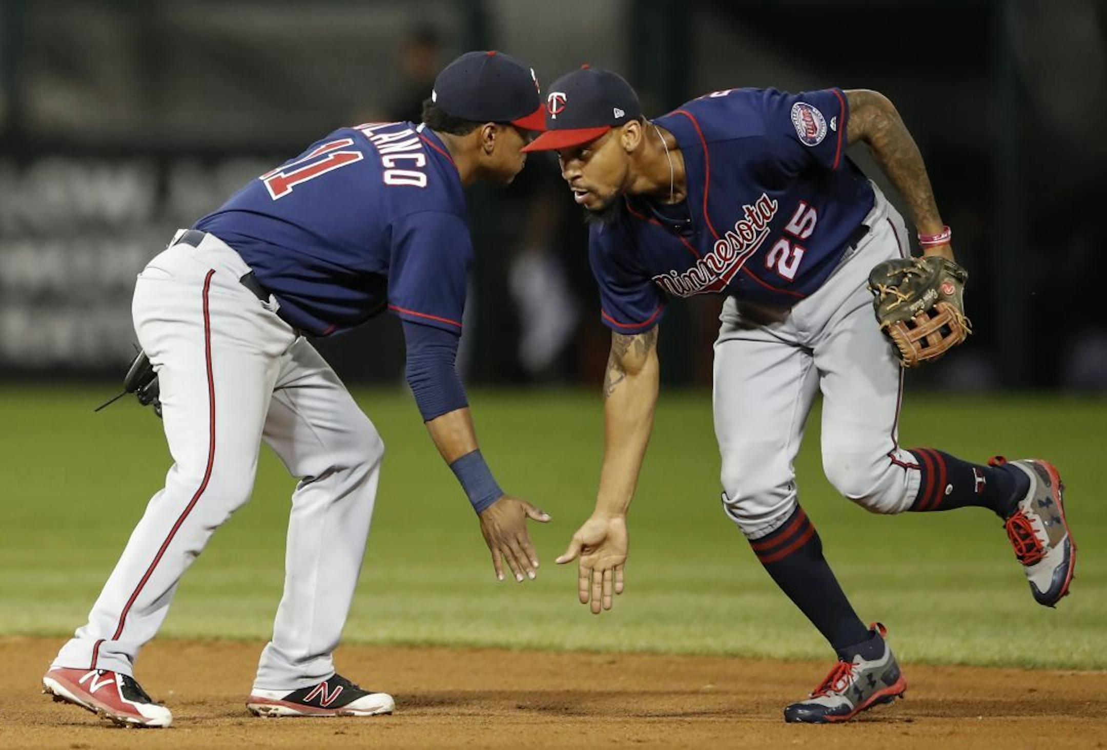 Minnesota Twins' Jorge Polanco (11) celebrates a win agains the Chicago White Sox with Byron Buxton (25) after Game 2 of a baseball doubleheader, Monday, Aug. 21, 2017, in Chicago.