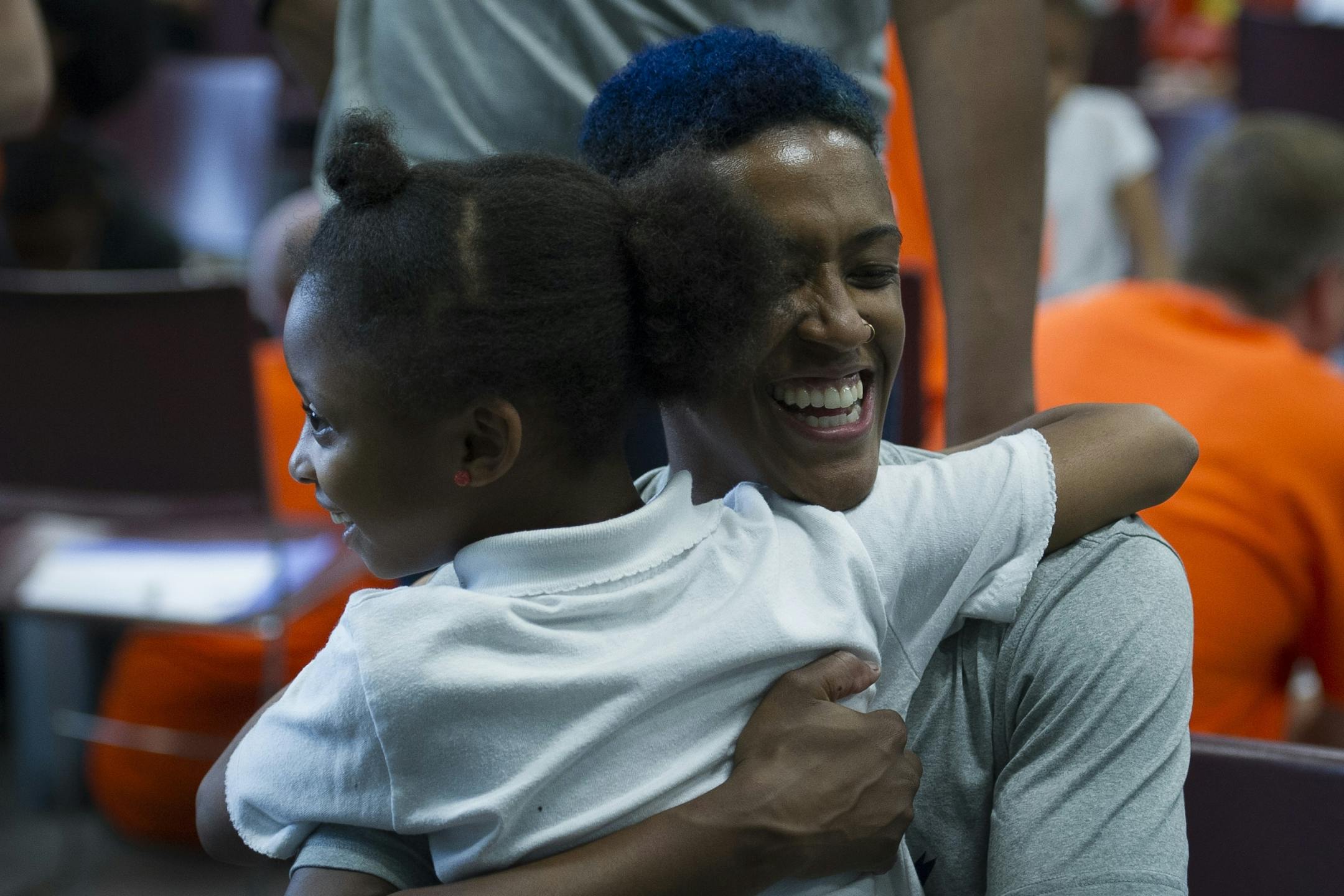 WNBA Champion Minnesota Lynx guard Danielle Robinson hugs a student after washing her feet and tying on a new pair of Nike Jordan shoes at Payne Elementary School in Washington, Wednesday, June 6, 2018. Payne Elementary has the highest homeless student population in the district.