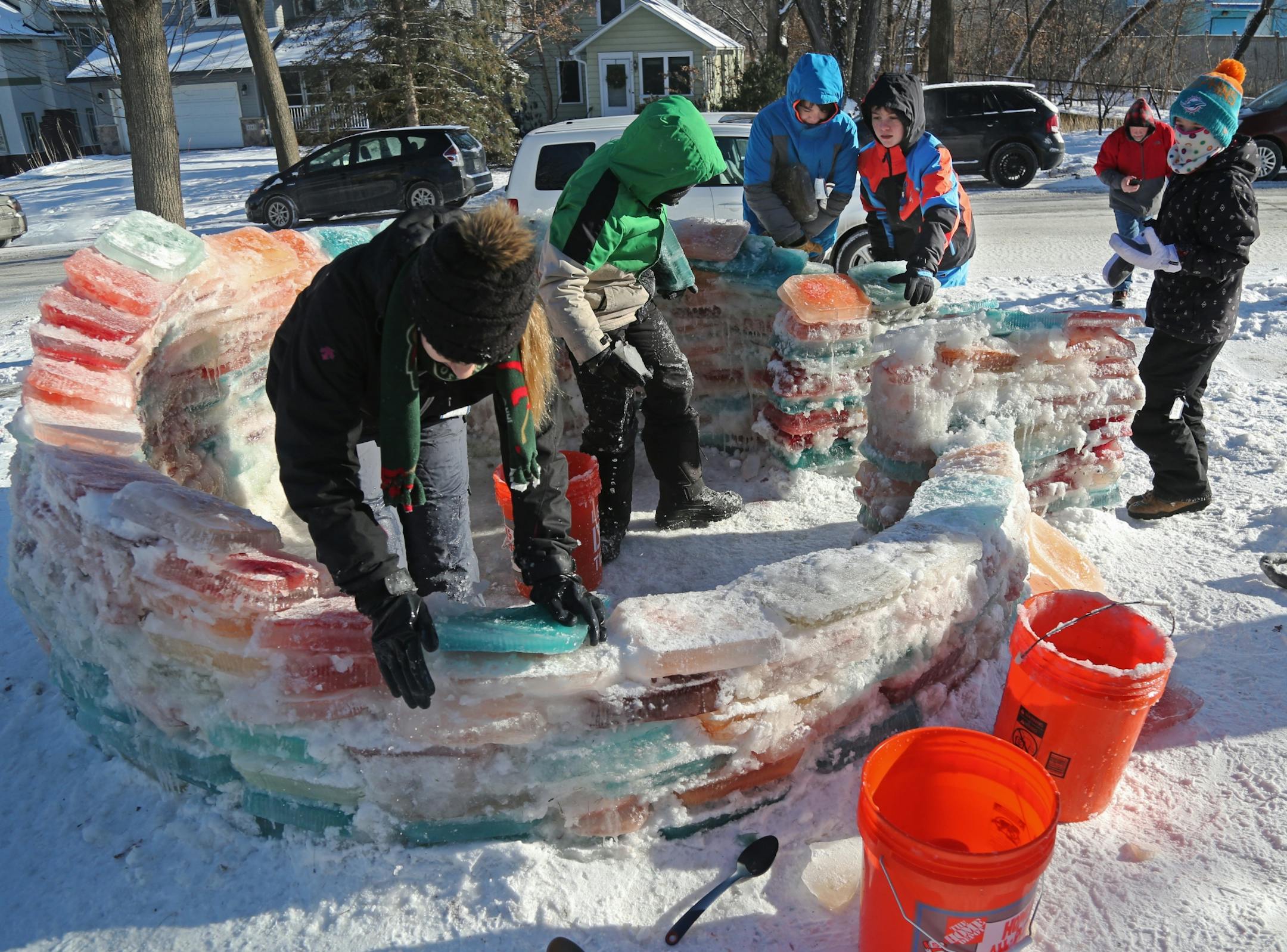 Martha Palm, her family and some former students of hers will be working on the multi-colored igloo they are building at the Palms' south Minneapolis home and seen Saturday, Dec. 30, 2017, in Minneapolis, MN. Here, the Palm children, neighbor children and a few former students of Martha Palm did much of the building of the igloo.