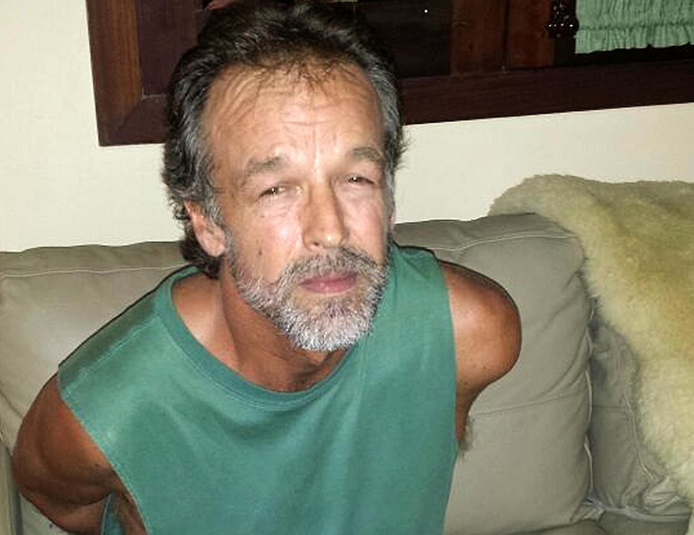 American sect leader Victor Arden Barnard sits in a police station after being detained at Pipa beach, in the Northeastern state of Rio Grande do Norte, Brazil, Friday, Feb. 27, 2015. Barnard is facing 59 counts of criminal sexual conduct related to two young women who said they were abused for nearly a decade at his secluded River Road Fellowship in Minnesota.