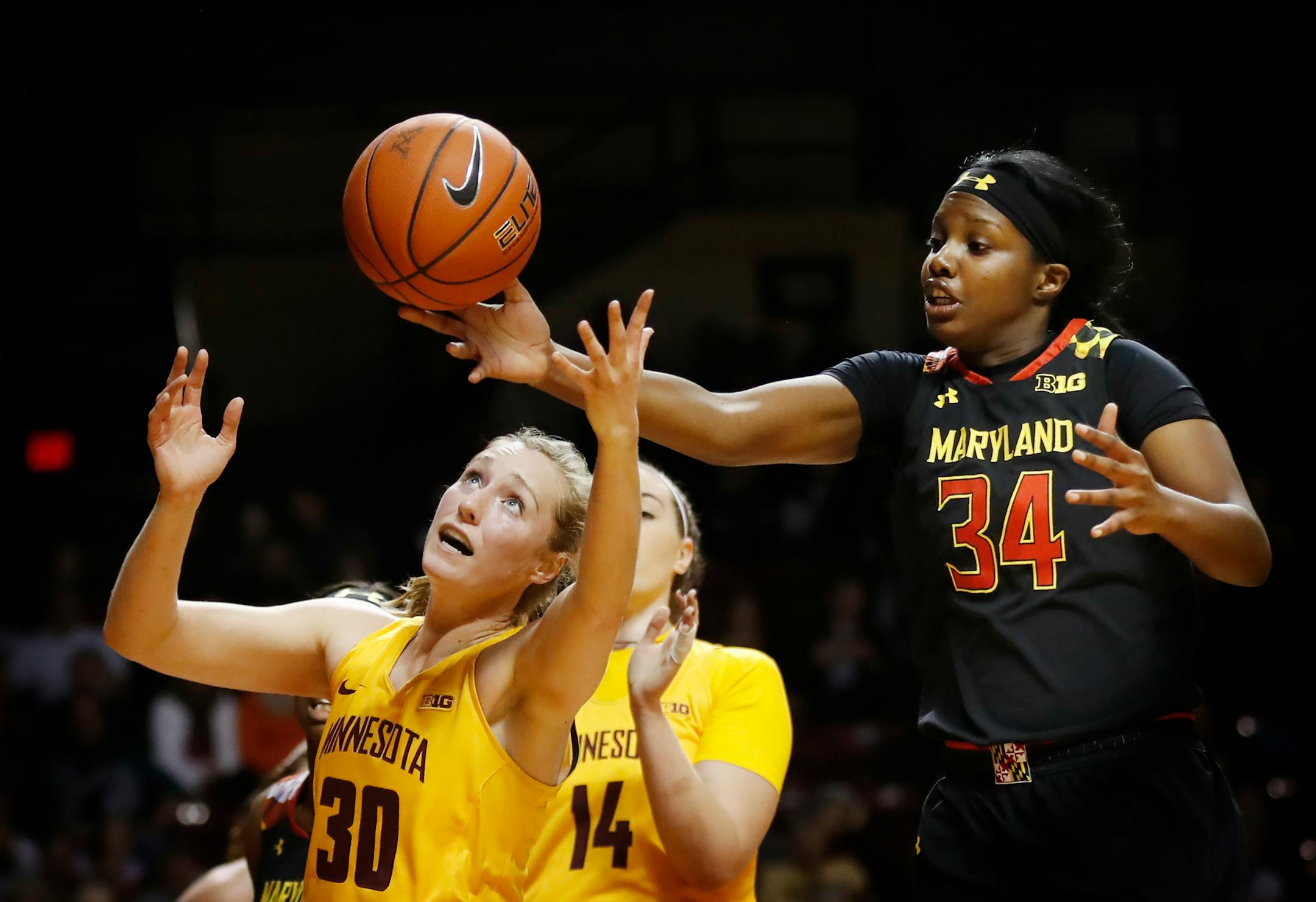 Maryland Terrapins forward Brianna Fraser (34) tipped the ball away from Minnesota Gophers forward Whitney Tinjum (30) during the Big Ten home opener at Williams Arena