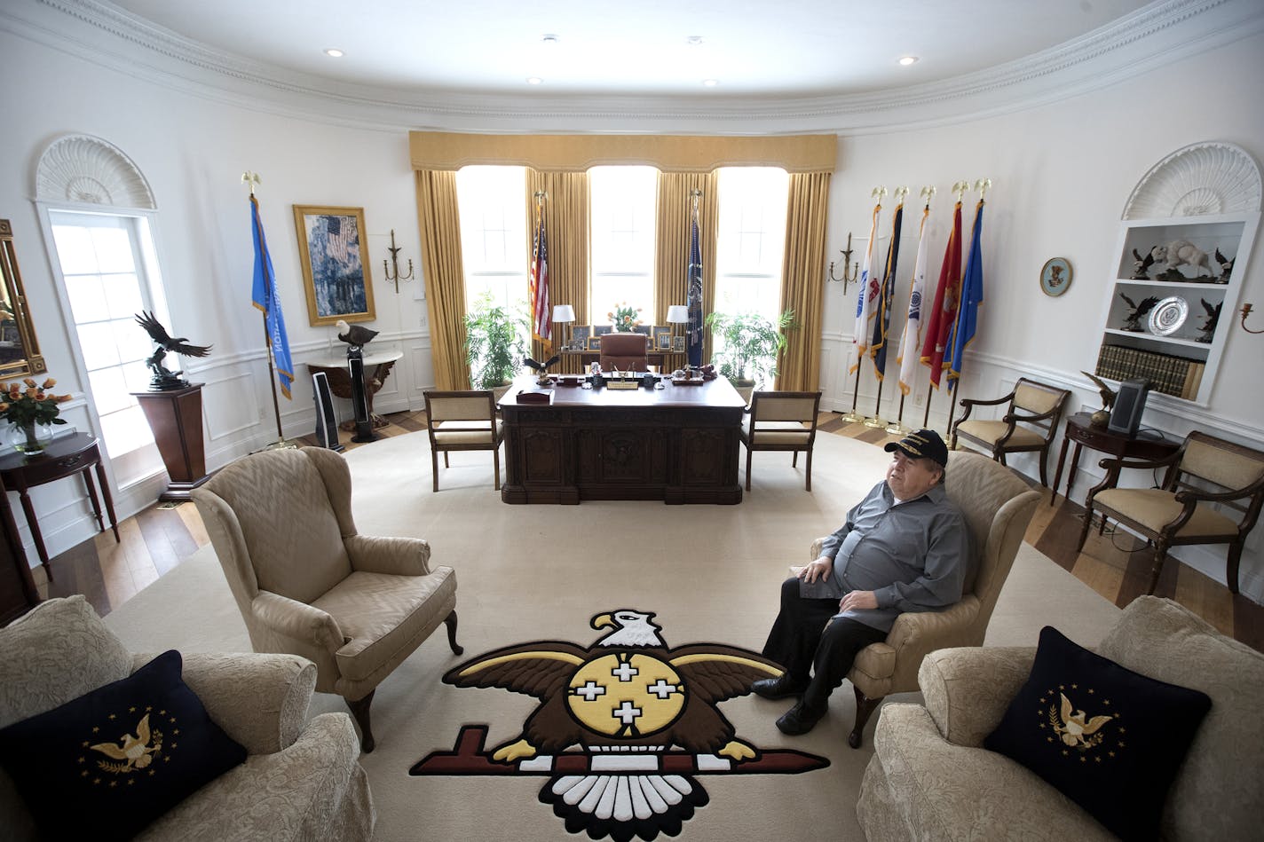 Glynn Crooks created the bald eagle and peace pipe design in the rug decorating his replica Oval Office. His vast collection of presidential memorabilia fills walls and glass cases in his home, including this Reagan room.