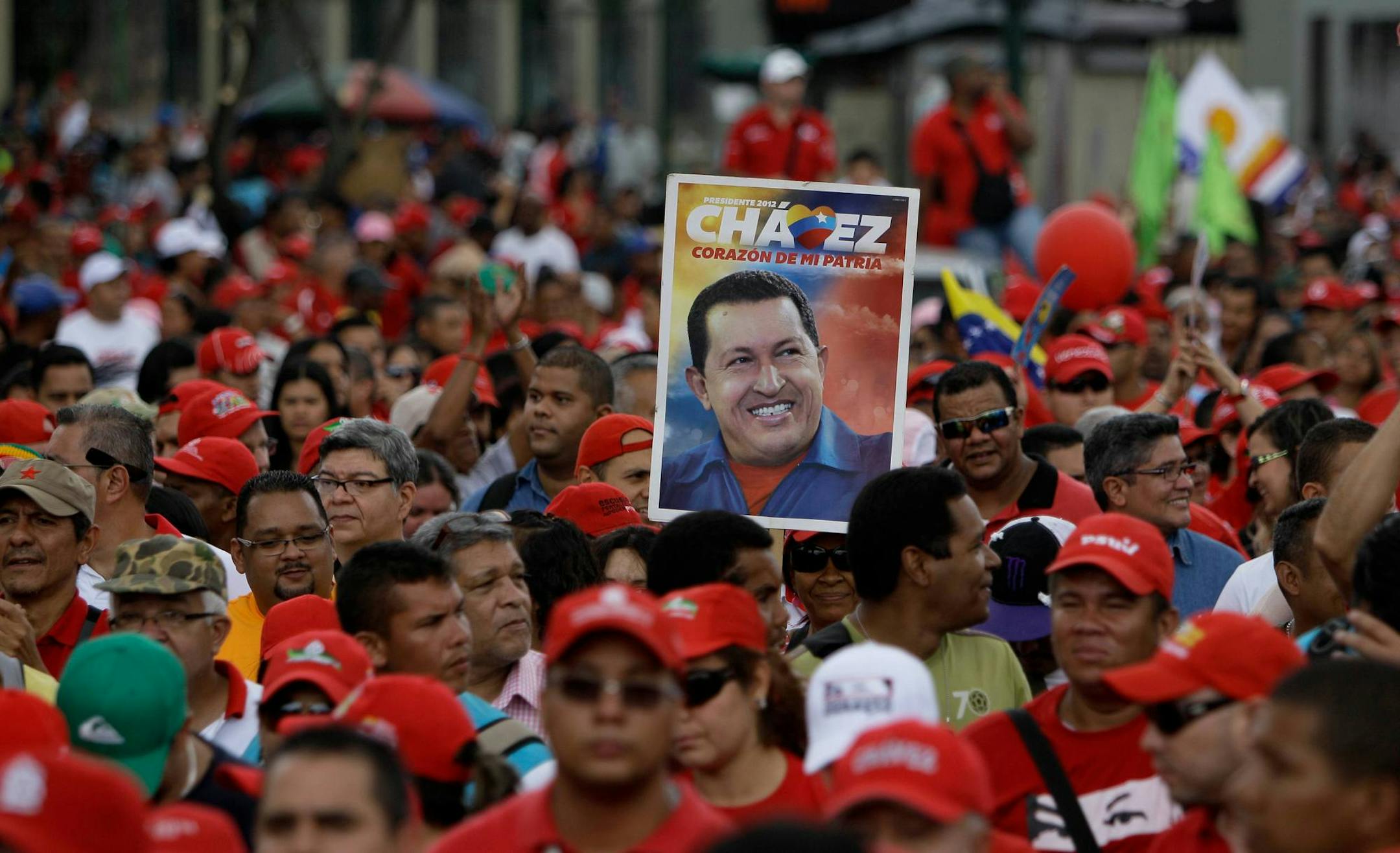 A supporter of Chavez held up a poster while marching in a parade last week marking the anniversary of a 1992 failed coup attempt led by Chavez. The president remains hospitalized with cancer in Cuba.