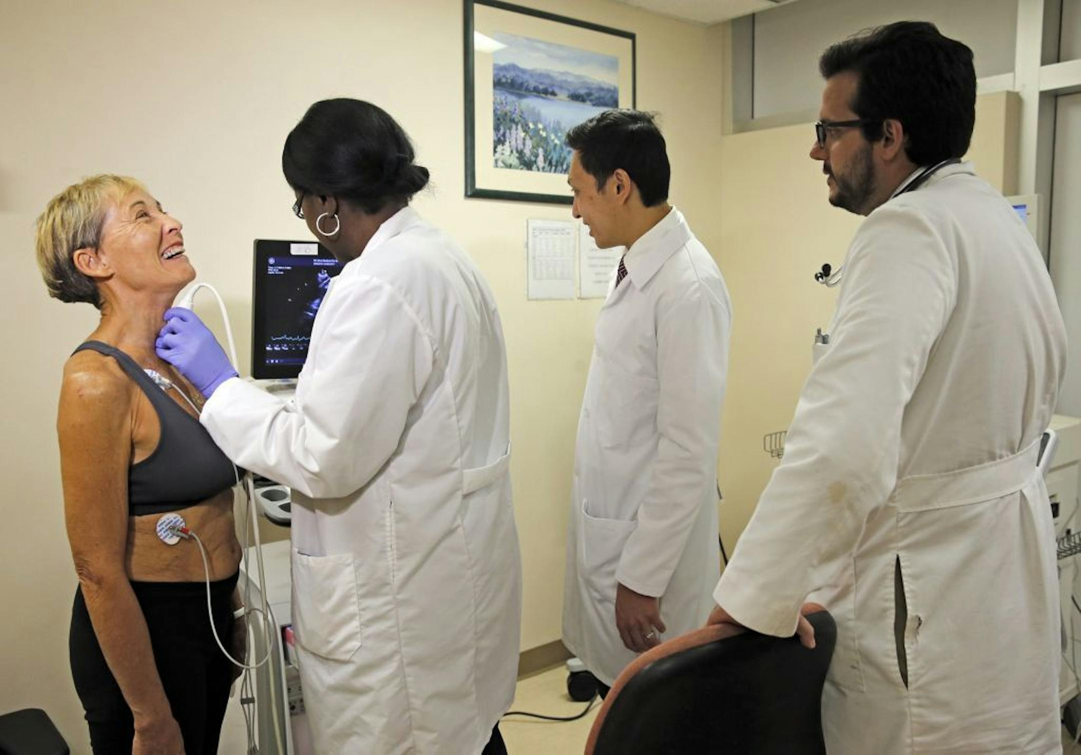 Angela McCaskill, Dr. Jeffrey Lin and Dr. Carlos Podesta examine patient Sally Mertens, 74, far left, at Mount Sinai Medical Center on Sept. 22, 2016 in Miami Beach, Fla.