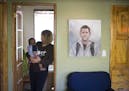 Hannah Lieder held her foster son Louis at home on Monday, May 4, 2015, in Minneapolis, Minn. On the wall next to her is a painting of her son who die