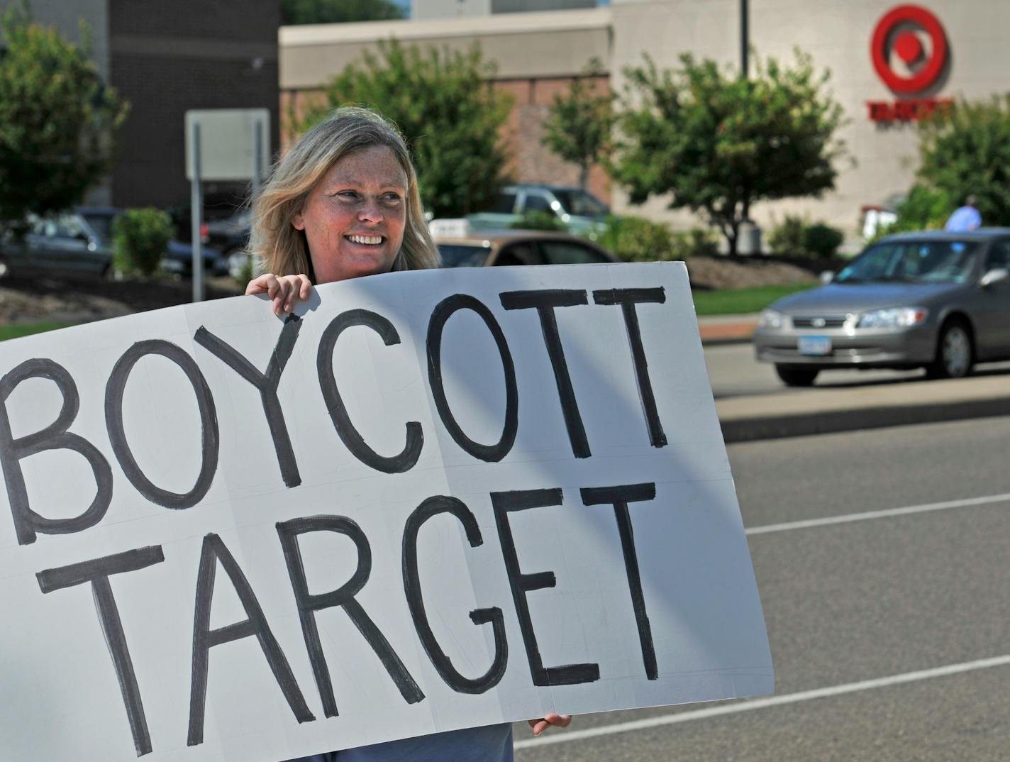 In this photo taken July 24, 2010, Laura Hedlund, 48 of Eagan, protests in front of a Target store after Target donated money to a PAC that is supporting the Republican candidate in the governor's race in Bloomington, Minn.