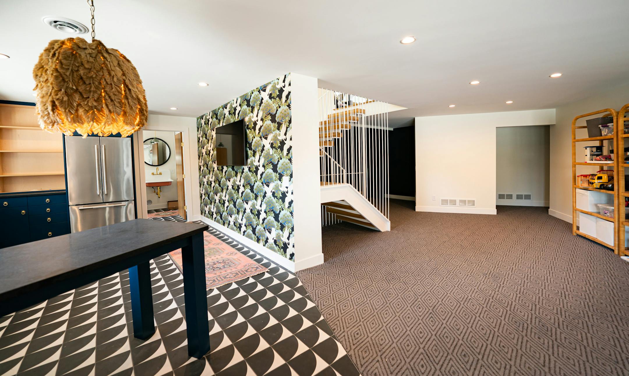 Lower level bar, kids play area and media room. Palm leaf lighting fixture from Anthropologie.