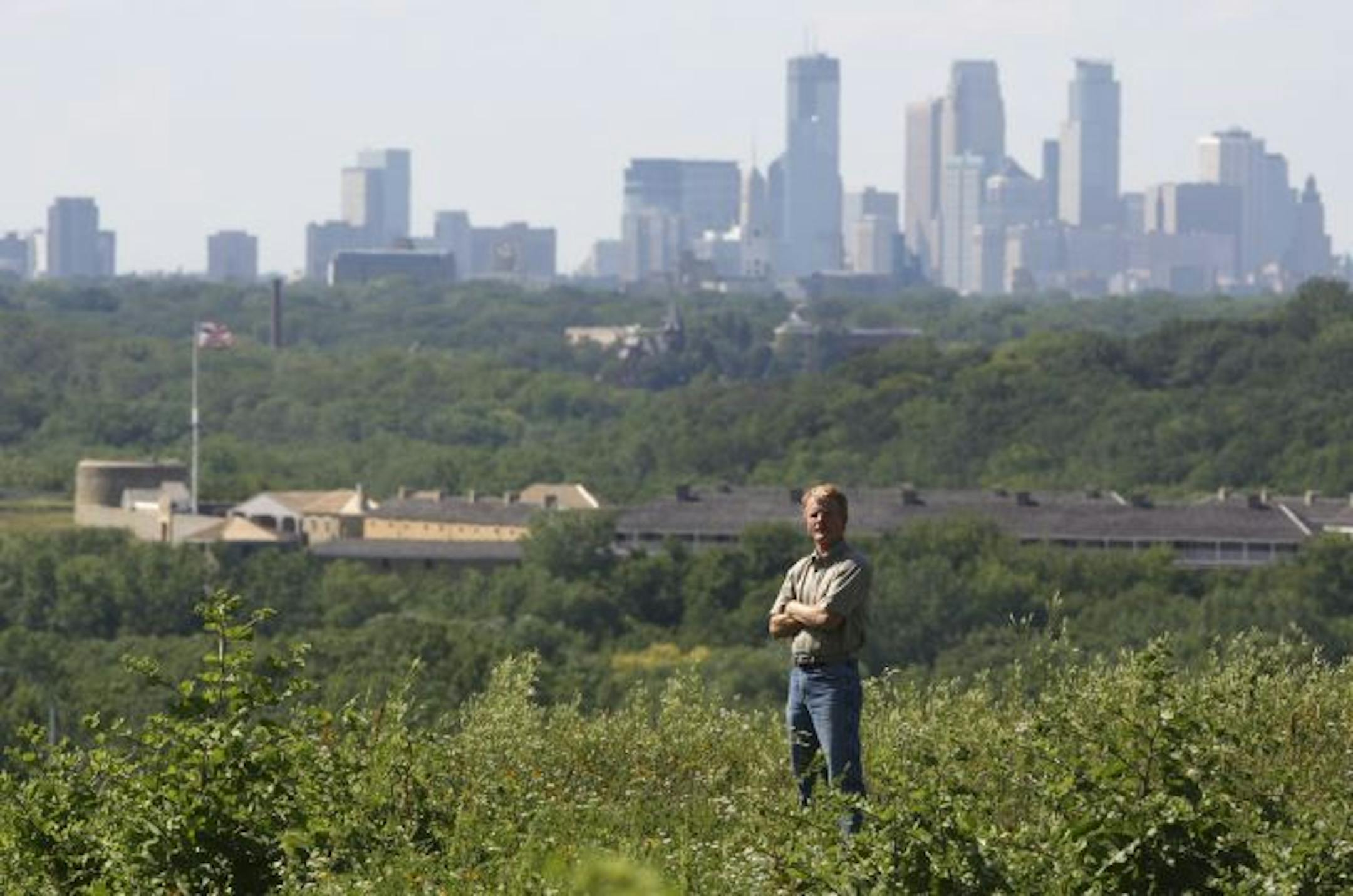 State Archeologist Scott Anfinson stands atop Pilot Knob in Mendota Heights Wednesday afternoon. He identified the site as an Indian burial site, ultimately halting development of the land across the river from the site of the first white presence in the area, Fort Snelling, and the later, much larger development -- the city of Minneapolis.