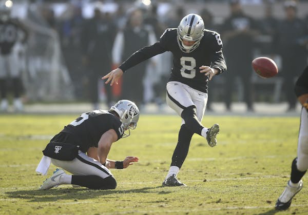 Oakland Raiders kicker Daniel Carlson (8) kicks a field goal from the hold of Johnny Townsend during the first half of an NFL football game against th
