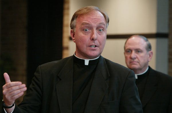 Father Kevin McDonough, left, in a 2002 file photo. House members say McDonough, the former vicar general of the archdiocese, personally lobbied them 