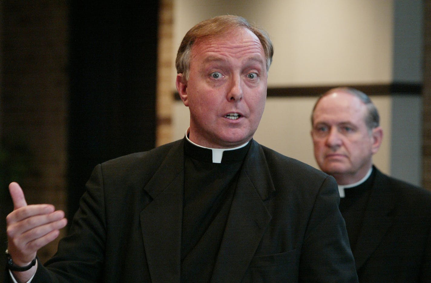 Father Kevin McDonough, left, in a 2002 file photo. House members say McDonough, the former vicar general of the archdiocese, personally lobbied them to maintain the statute of limitations.