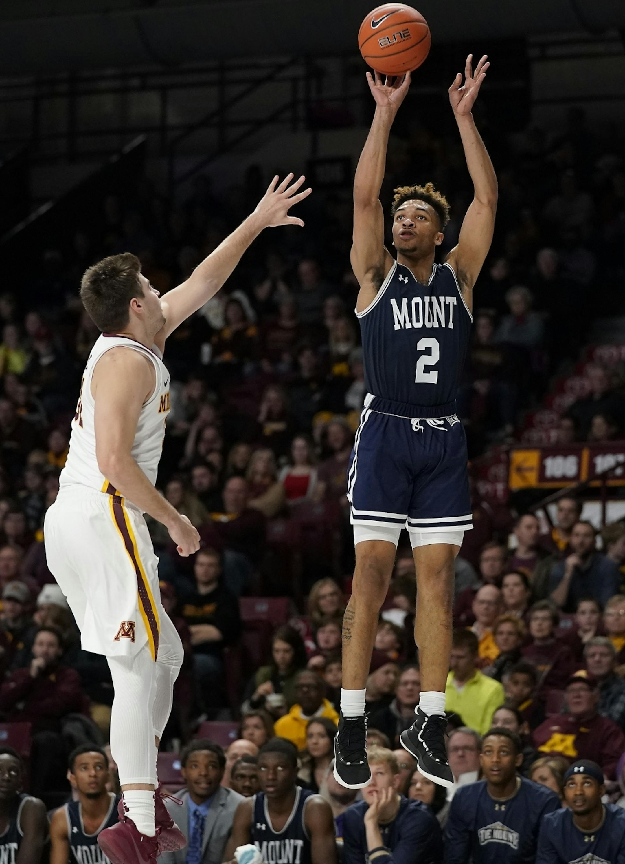 Mount St. Mary's guard Dee Barnes (2) shoots as Minnesota guard Brock Stull (31) defends during the second half.